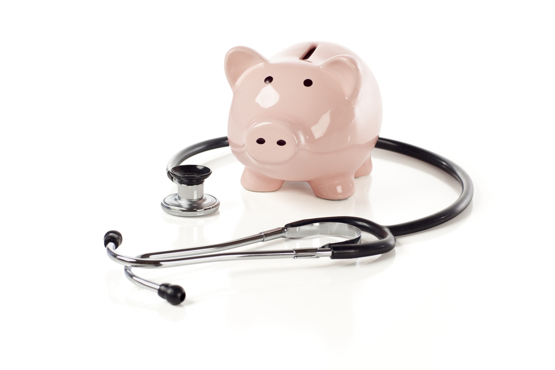 Piggy Bank and Stethoscope Isolated on a White Background with Slight Shadow.